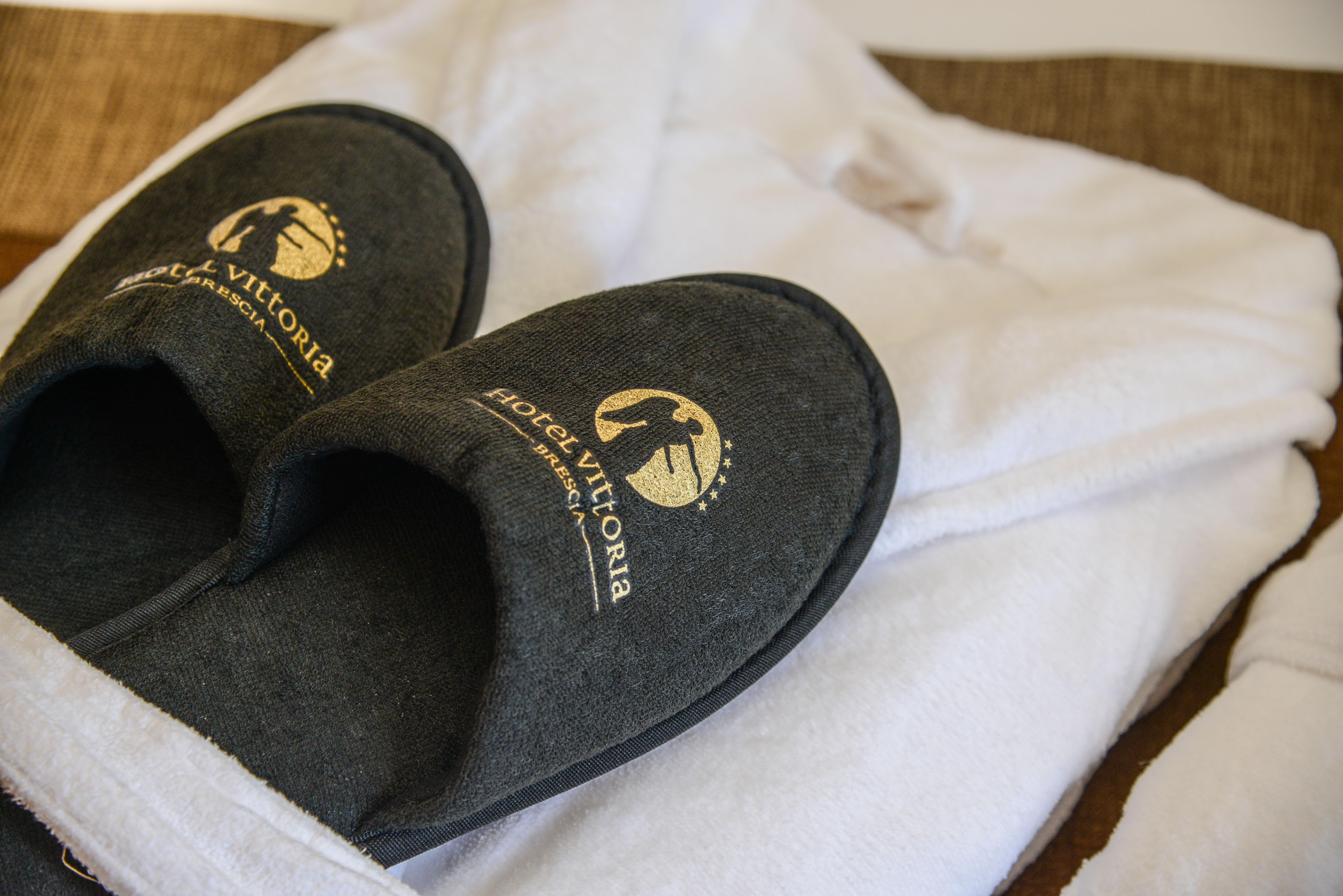 Hotel Vittoria Brescia Exterior photo Slippers and bathrobe